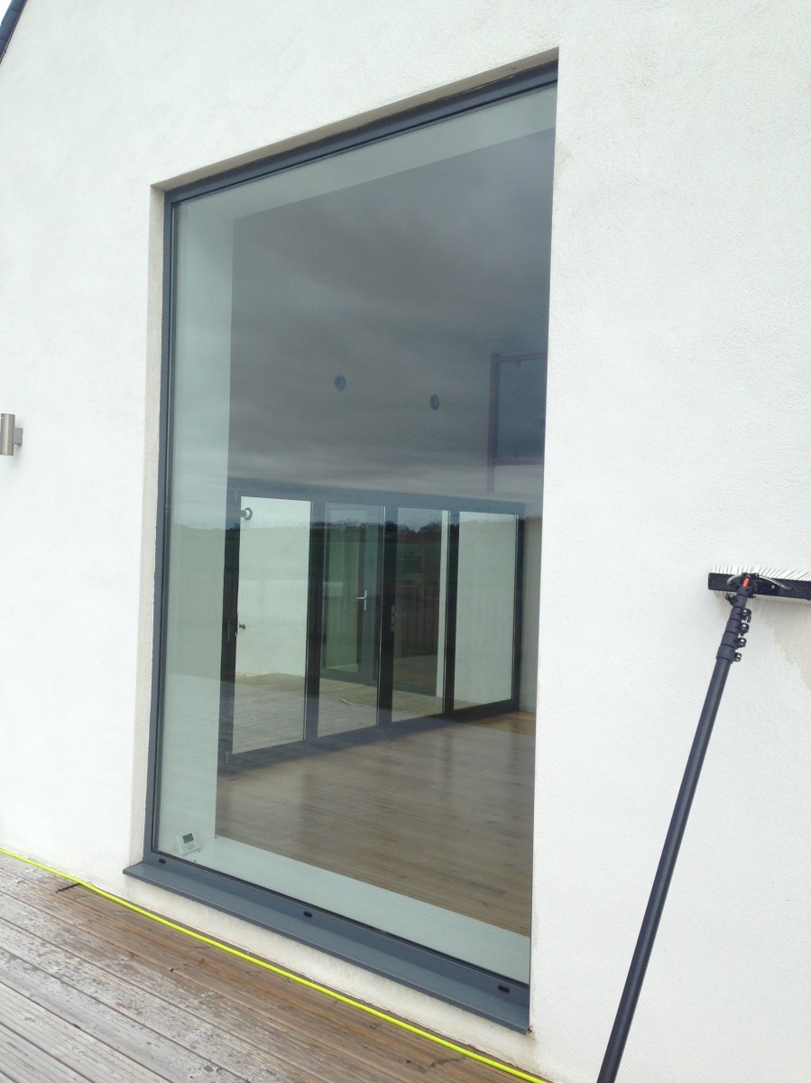 Window with cleaning pole propped to the side