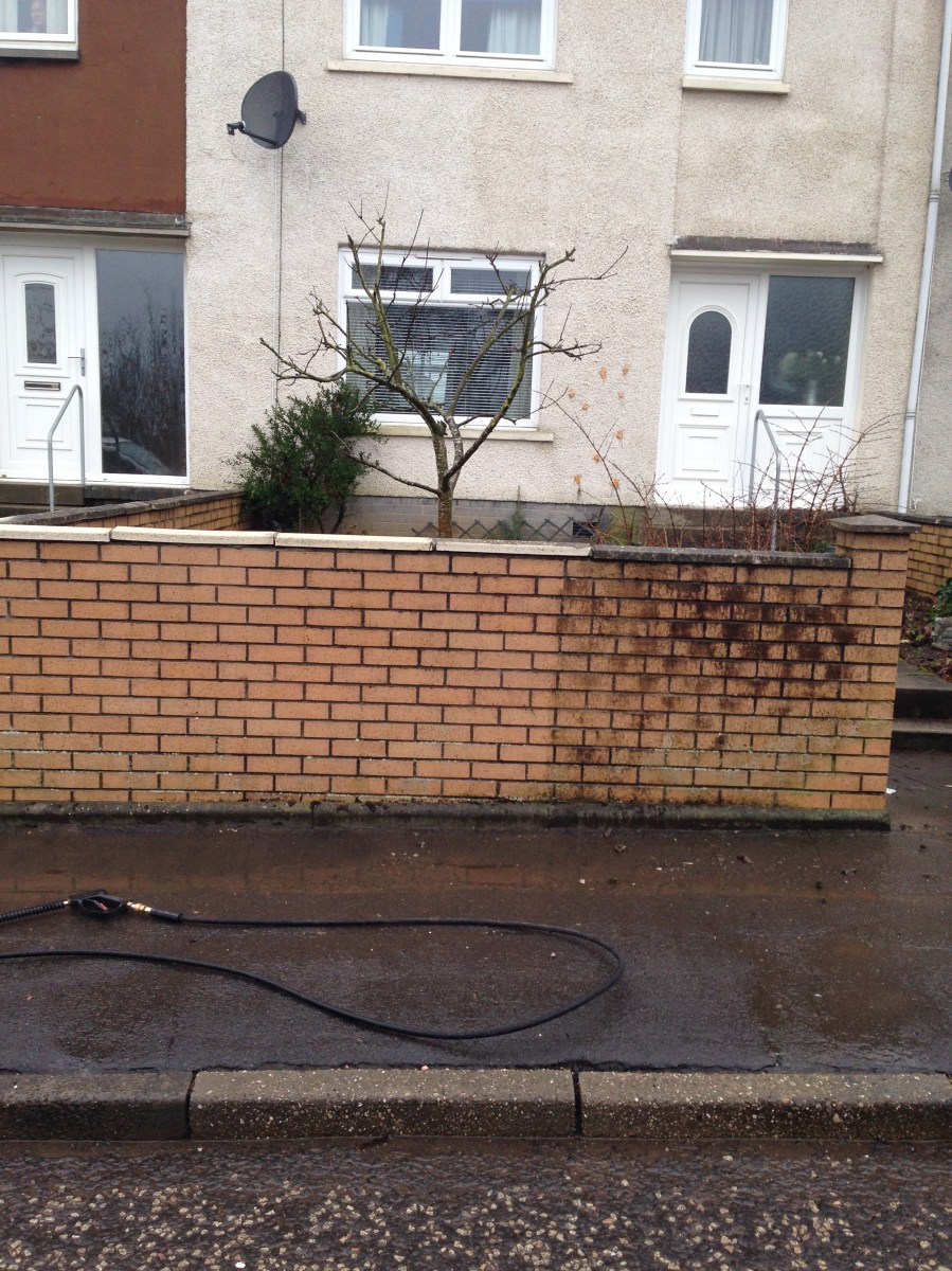 Partially cleaned brick wall